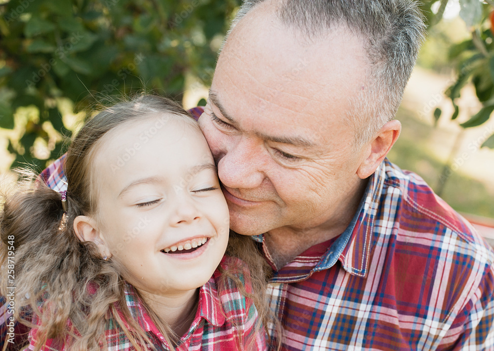 grandfather with granddaughter. Multi generation family enjoying in the park. grandfather with granddaughter. Multi generation family enjoying in the park.