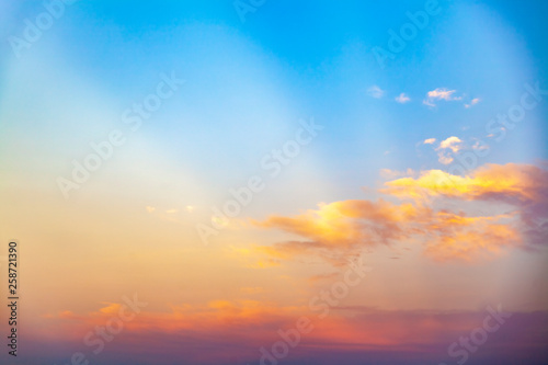 beautiful blue sunset sky with white clouds background, Nature background, yellow and orange tone. © BrightSpace