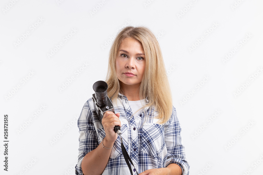 People, photographer and gesture concept - woman using an old fashioned camera on white background People, photographer and gesture concept - woman using an old fashioned camera on white background