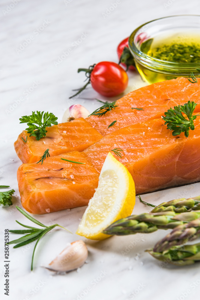 Cold smoked salmon fish fillets on white marble table Cold smoked salmon fish fillets on white marble table
