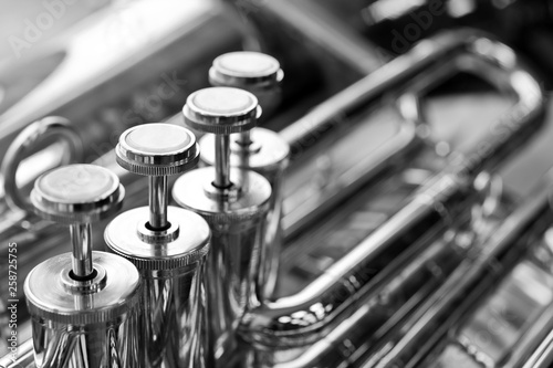 Fragment of a bass tuba valves closeup in black and white
