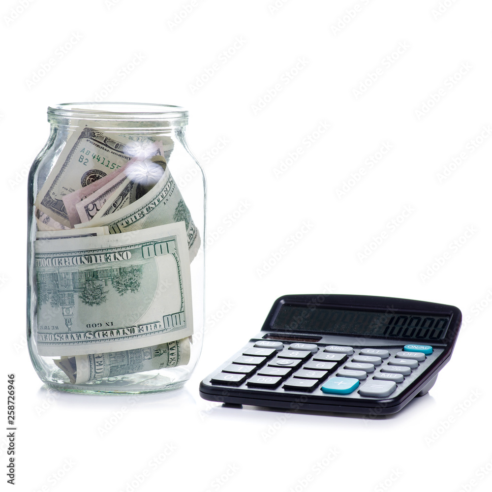 Fototapeta premium Money dollars bank notes in glass jar and calculator isolated on white background, concept save money