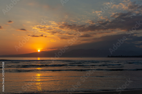 Beautiful sunrise or sunset over mountains and ocean 