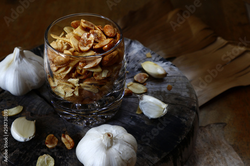 Toasted peanuts and fried garlic chips on a glass