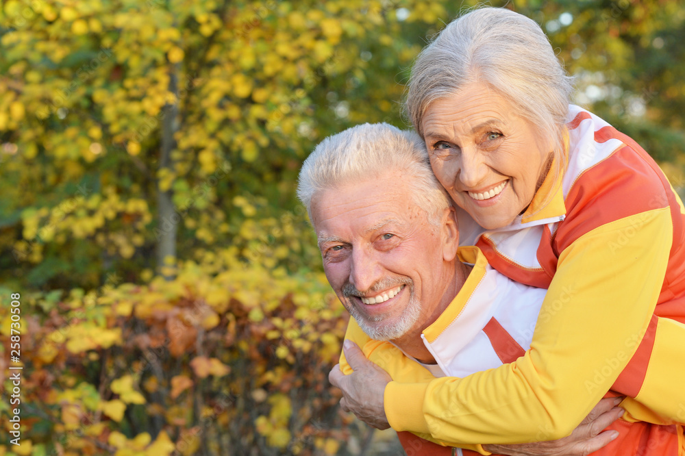 Portrait of happy fit senior couple in autumn park Portrait of happy fit senior couple in autumn park