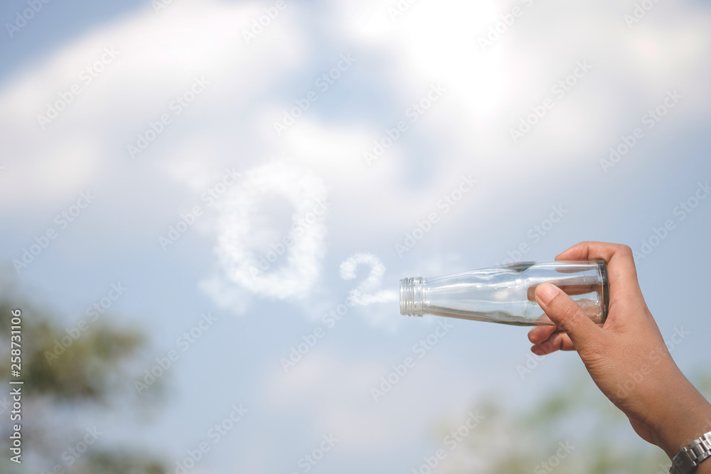 Hands holding glass jar for keeping fresh air O2 cloud word with