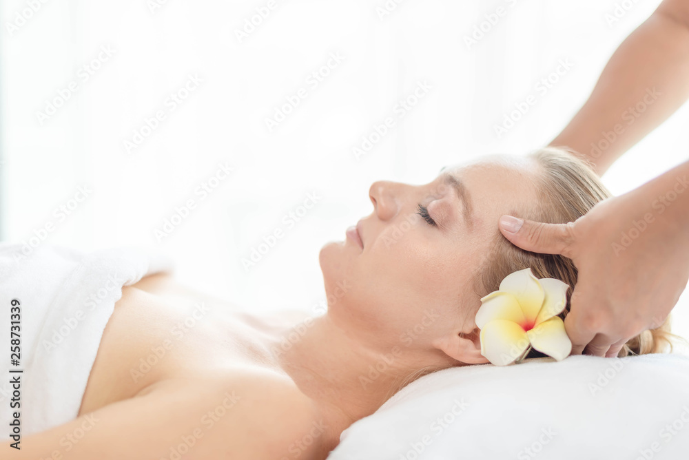 Beautiful young woman relaxing with hand massage at beauty spa. Face massage. Closed up of young beautiful woman getting spa massage treatment at beauty spa salon. Beautiful young woman relaxing with hand massage at beauty spa. Face massage. Closed up of young beautiful woman getting spa massage treatment at beauty spa salon.