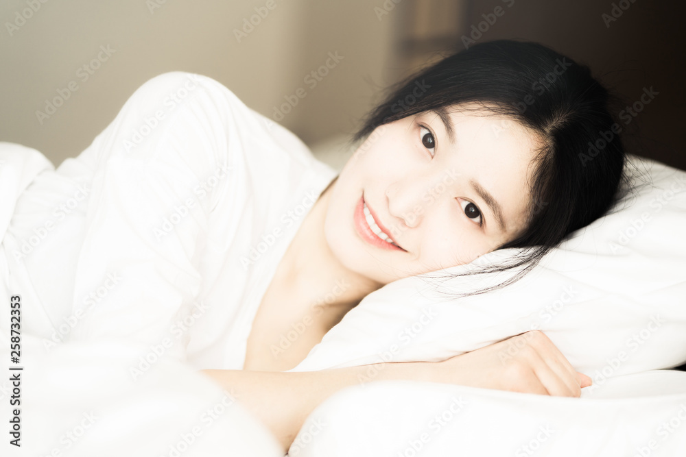 Young Asian woman, resting in bed Young Asian woman, resting in bed