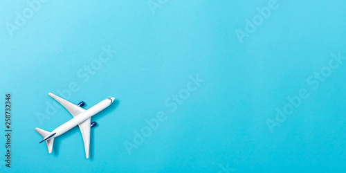 A toy airplane on a blue paper background