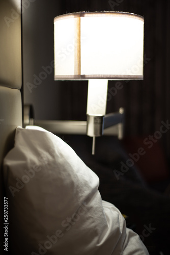 Close up of lamp and pillow at hotel
