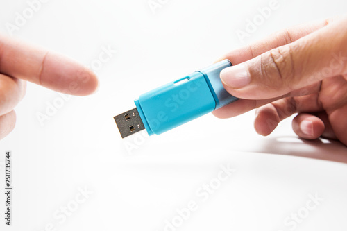 Digital data memory concept.Hand holding pendrive on white background