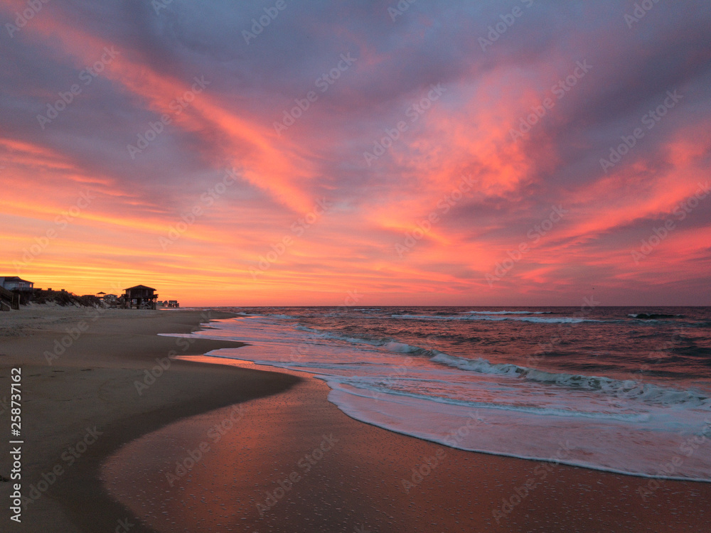 Amazing orange, pink, red, and purple sunset along the beach in the outer banks of North Carolina