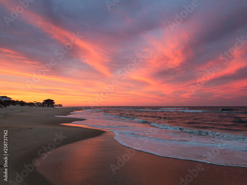 Amazing orange, pink, red, and purple sunset along the beach in the outer banks of North Carolina