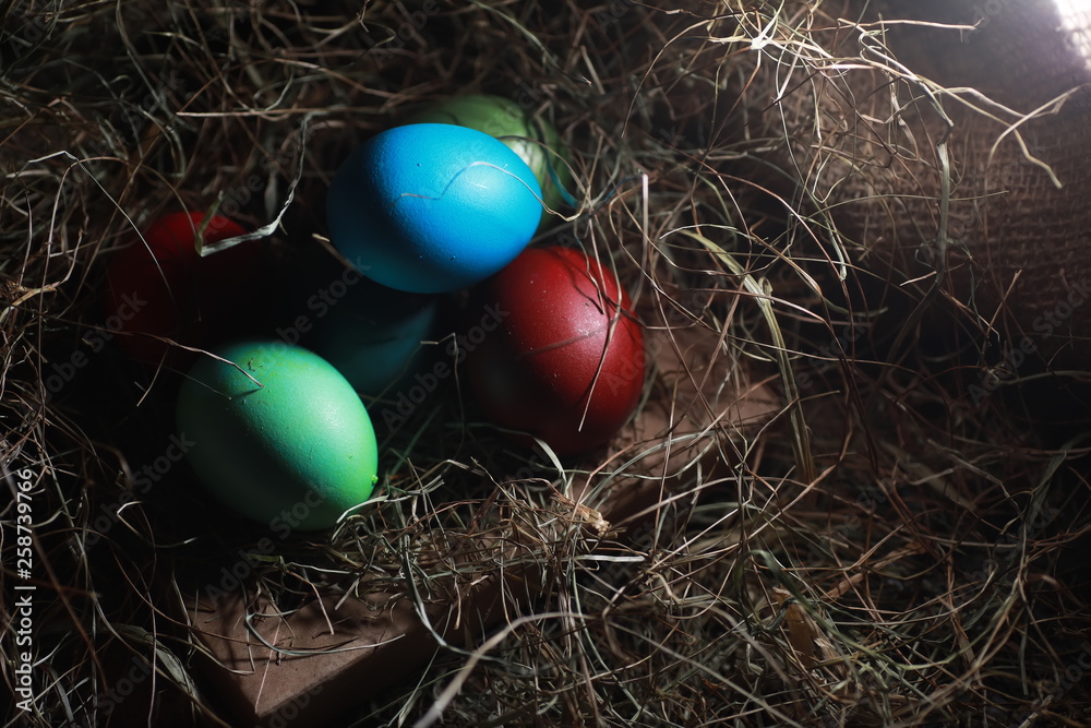 Fototapeta premium Easter painted eggs on burlap