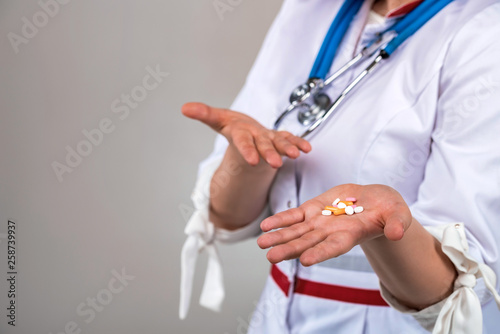 Close up doctor holding medical drugs or pills in hand