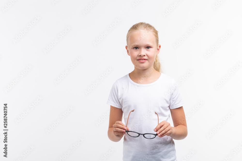 Beautiful child girl with glasses on white background with copy space Beautiful child girl with glasses on white background with copy space