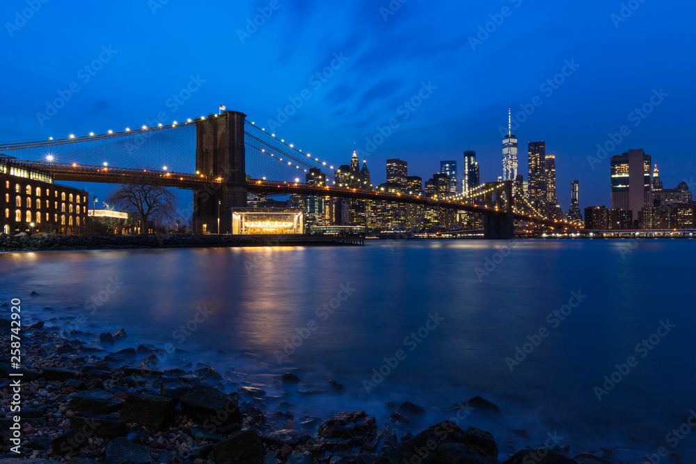 Brooklyn Bridge in Manhattan downtown with Cityscape at night New York USA