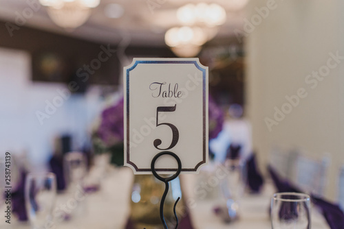 Wedding Reception table number five place card on puple table setting