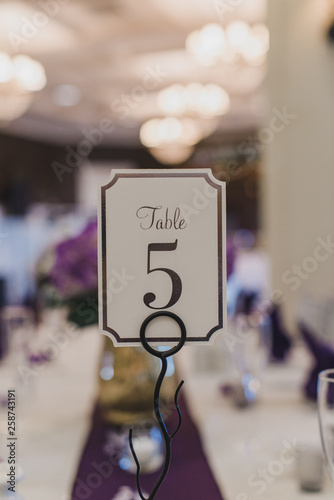 Wedding Reception table number five place card on puple table setting