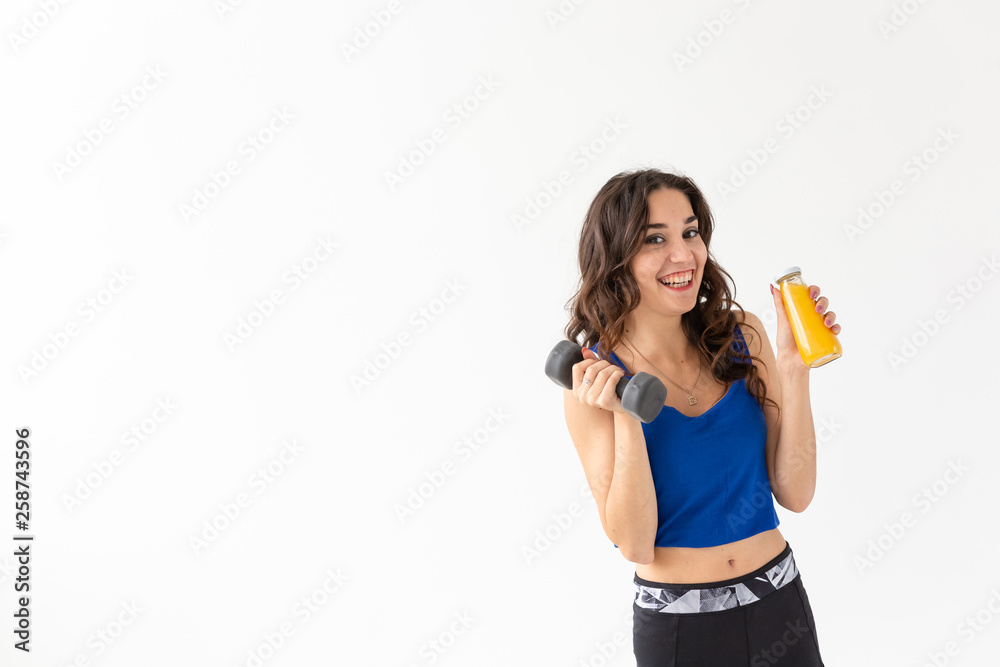 Healthy lifestyle, people and sport concept - Woman with healthy juice drinking for sport and fitness on white background with copy space Healthy lifestyle, people and sport concept - Woman with healthy juice drinking for sport and fitness on white background with copy space