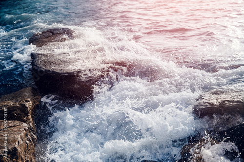 Background of blue sea water surface with white foam