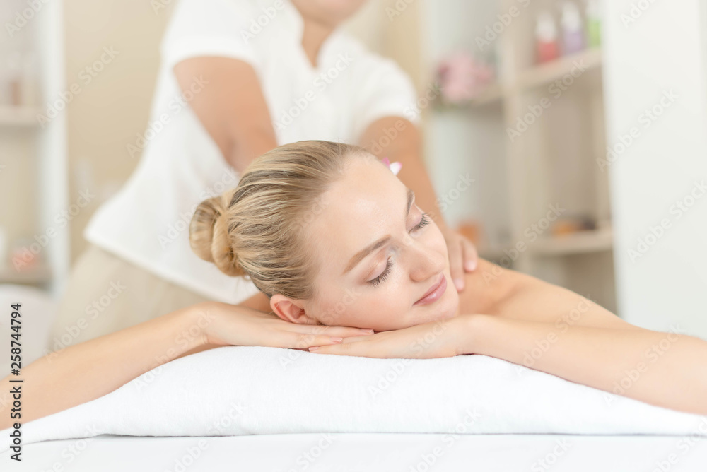 Beautiful young woman relaxing with hand massage at beauty spa. Body massage. Closed up of young beautiful woman getting spa massage treatment at beauty spa salon. Beautiful young woman relaxing with hand massage at beauty spa. Body massage. Closed up of young beautiful woman getting spa massage treatment at beauty spa salon.