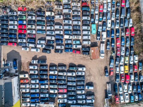 Lines of crushed cars wreck in scrapyard before being shredded recyling photo