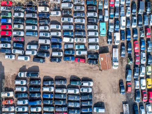 Lines of crushed cars wreck in scrapyard before being shredded recyling photo