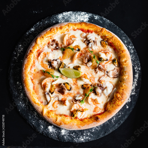 sefood pizza on the black background photo