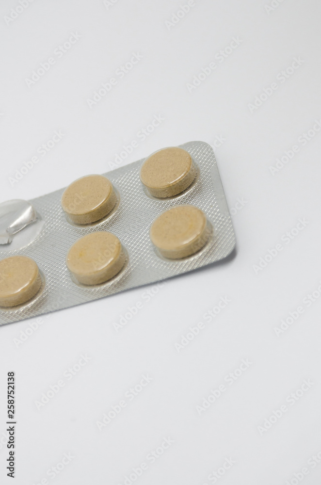 A packing of brown medical pills A packing of brown medical pills
