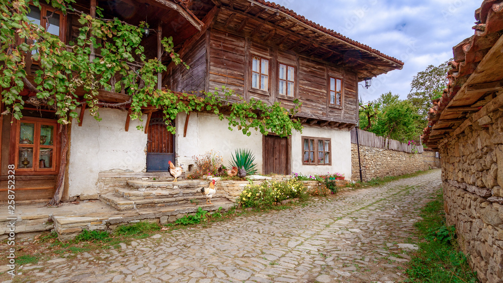 Village of Zheravna. Hens roam freely outside old traditional Bulgarian house. Village of Zheravna. Hens roam freely outside old traditional Bulgarian house.
