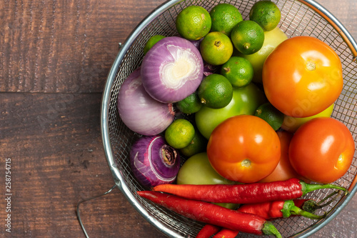 Fototapeta Naklejka Na Ścianę i Meble -  vegetables tomatoes, onions, limes, red peppers on wooden background