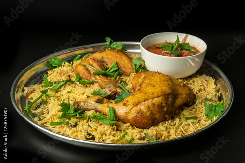 chicken mandy rice set with spicy sauce and salad isolated on dark background