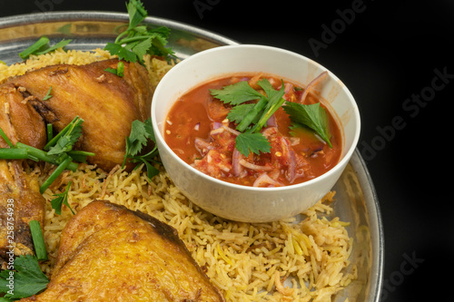 chicken mandy rice set with spicy sauce and salad isolated on dark background