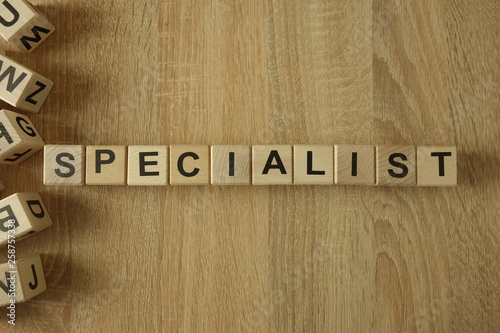Specialist word from wooden blocks on desk