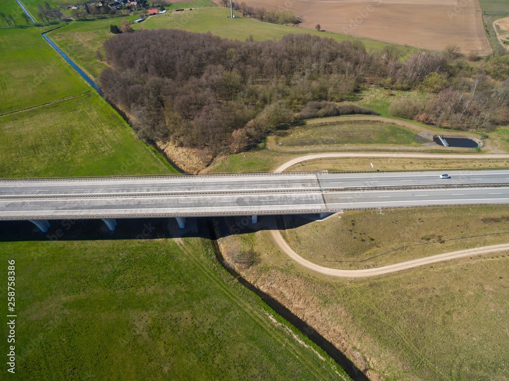 highway bridge in rural area - aerial view of a big highway bridge in rural area in germany european - cars drive over the highway bridge - drone flight