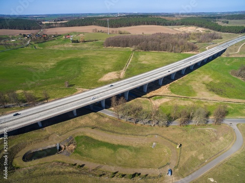 highway bridge in rural area - aerial view of a big highway bridge in rural area in germany european - cars drive over the highway bridge - drone flight