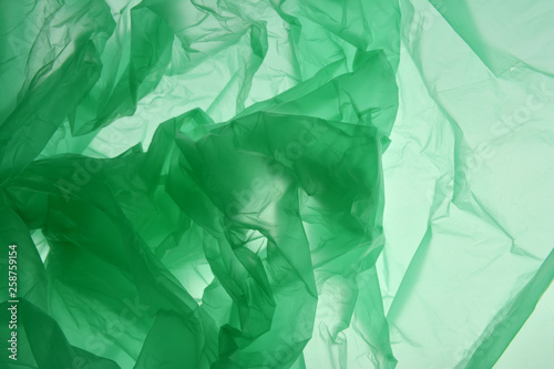 Plastic bag concept. Polyethylene as smoke may use as background. Emerald green textured gradient. Background for design. Template for card, poster, banner design.
