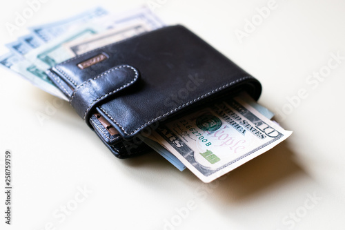 Leather wallet with dollar bills 
