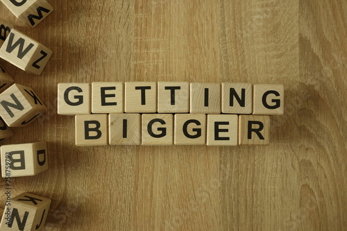 Getting bigger text from wooden blocks on desk photo