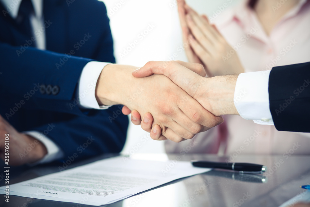 Business people shaking hands finishing up a meeting. Handshake at successful negotiation Business people shaking hands finishing up a meeting. Handshake at successful negotiation