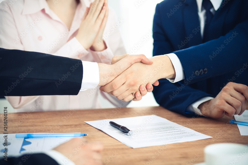 Business people shaking hands finishing up a meeting. Handshake at successful negotiation Business people shaking hands finishing up a meeting. Handshake at successful negotiation