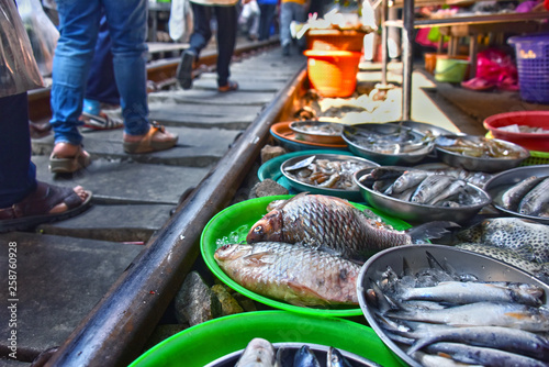 Selling food on the Maeklong Railway market in Thailand photo