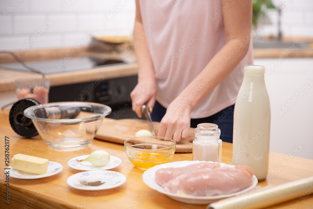 The image of a woman cutting onion The image of a woman cutting onion