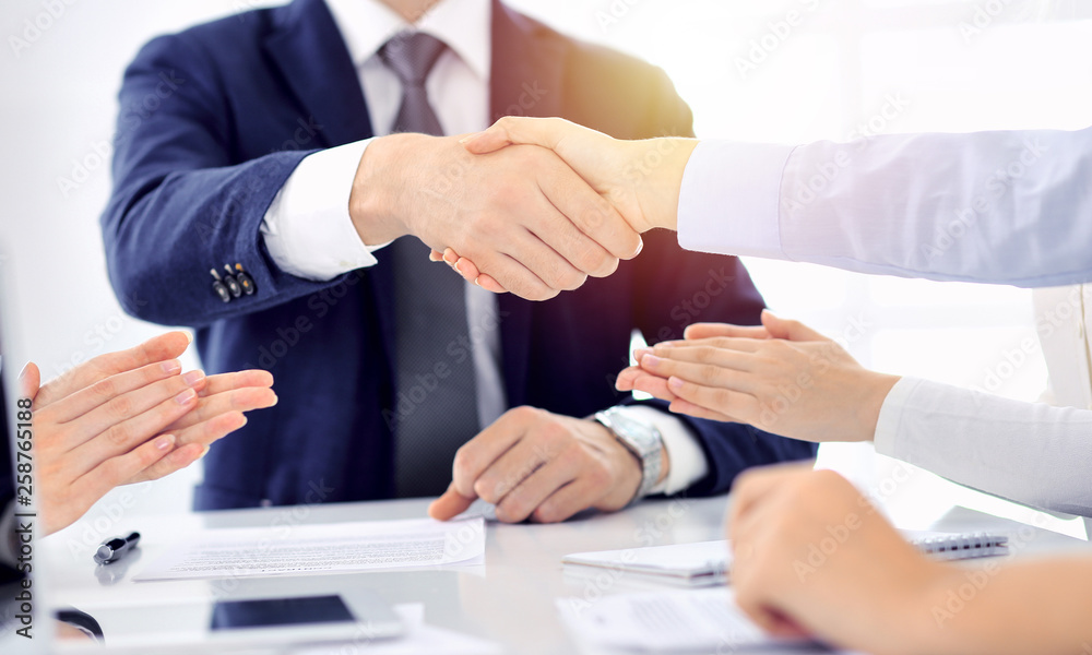 Group of business people or lawyers shaking hands finishing up a meeting , close-up. Success at negotiation and handshake concepts Group of business people or lawyers shaking hands finishing up a meeting , close-up. Success at negotiation and handshake concepts