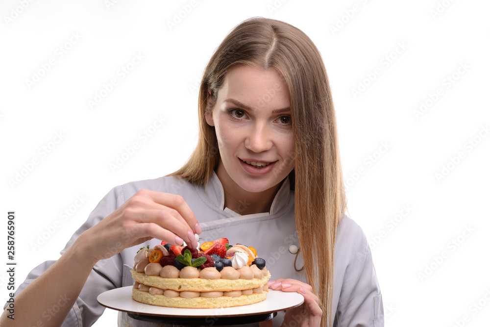 baker girl with a cake with berries on a white background baker girl with a cake with berries on a white background