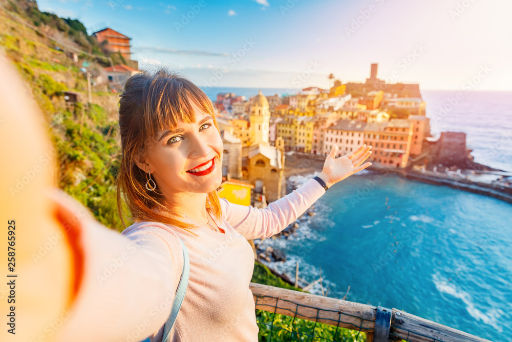 Tourist happy young woman taking selfie photo Vernazza, national park Cinque Terre, Liguria, Italy, Europe. Concept travel