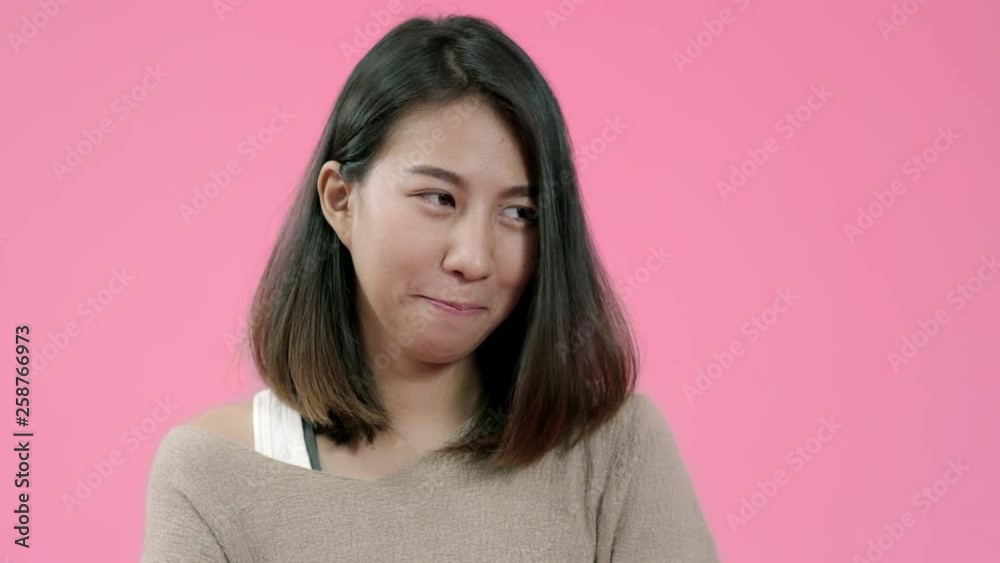 Smiling adorable Asian female with positive expression, smiles broadly, dressed in casual clothing and looking at the camera over pink background. Happy adorable glad woman rejoices success. Smiling adorable Asian female with positive expression, smiles broadly, dressed in casual clothing and looking at the camera over pink background. Happy adorable glad woman rejoices success.