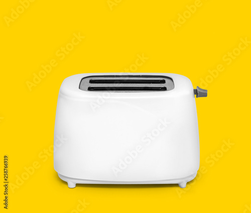 Modern toaster on yellow