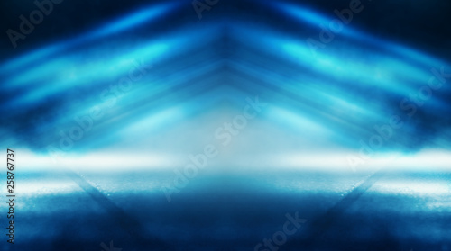 Background of empty dark room with rays of light. Concrete floor with light reflection. Smoke  neon blue light